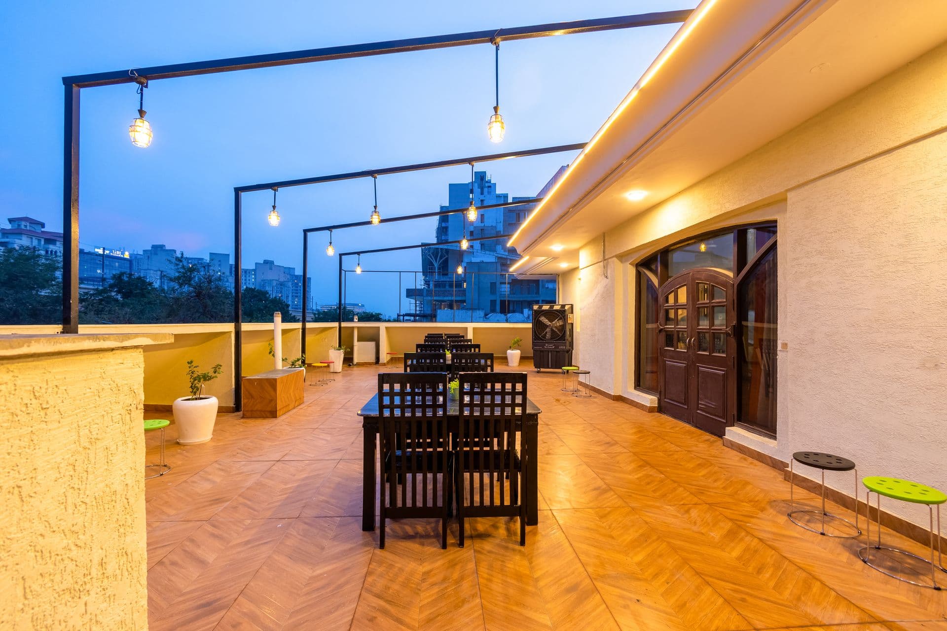 Rooftop party venue at Nook Inn & Suites lit up at dusk